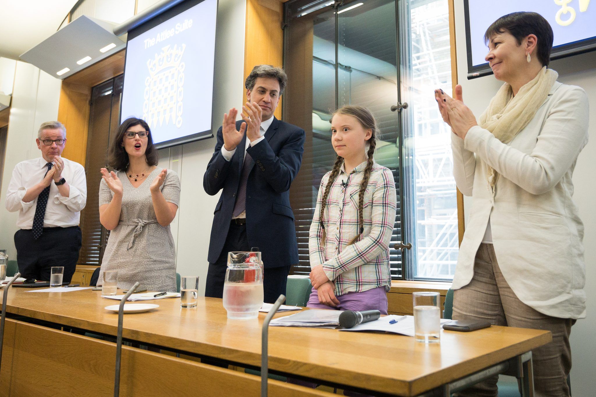 Swedish environmental campaigner Greta Thunberg (2R) receives applause after addressing politicians, media and guests within the Houses of Parliament on April 23, 2019 in London, England. Her visit coincides with the ongoing "Extinction Rebellion" protests across London, which have seen days of disruption to roads and transport systems, in a bid to highlight the dangers of climate change. (Photo by Leon Neal/Getty Images)