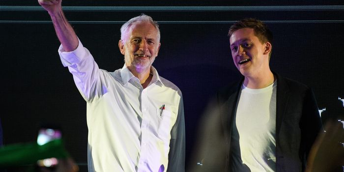 Jeremy Corbyn and Owen Jones stand together on stage
