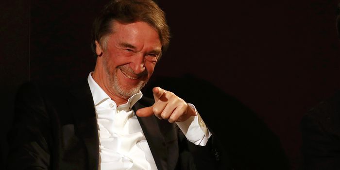 Sir Jim Ratcliffe smiles and points at a camera