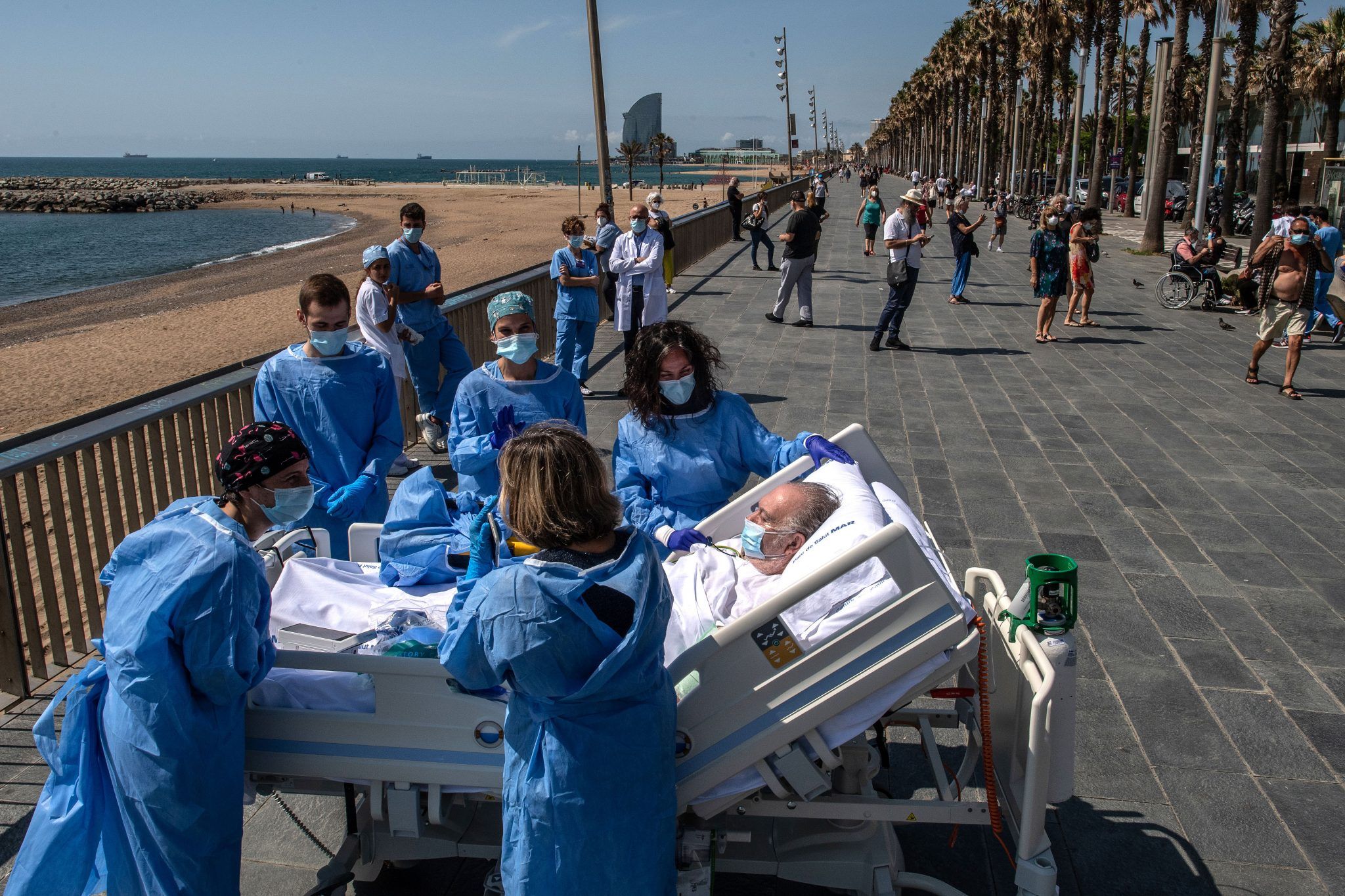 A patient recovering from coronavirus at Barcelona hospital is taken by doctors to the beach