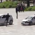 Man drop kicks through car window to save crowd from dangerous driver