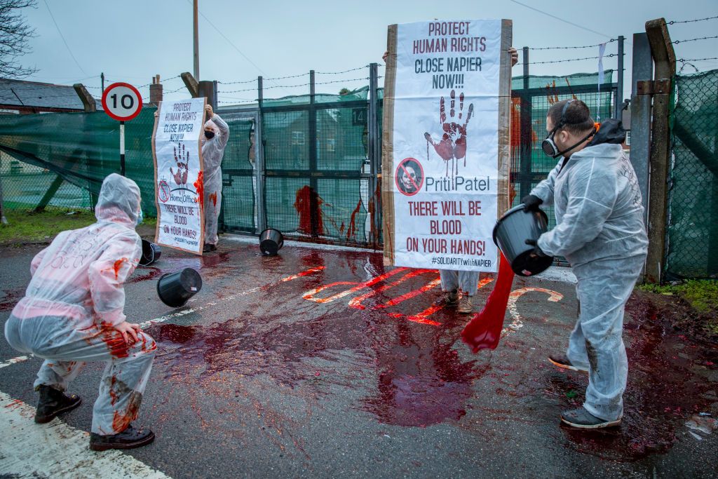 Protestors throw fake blood over poor conditions at Napier immigration barracks