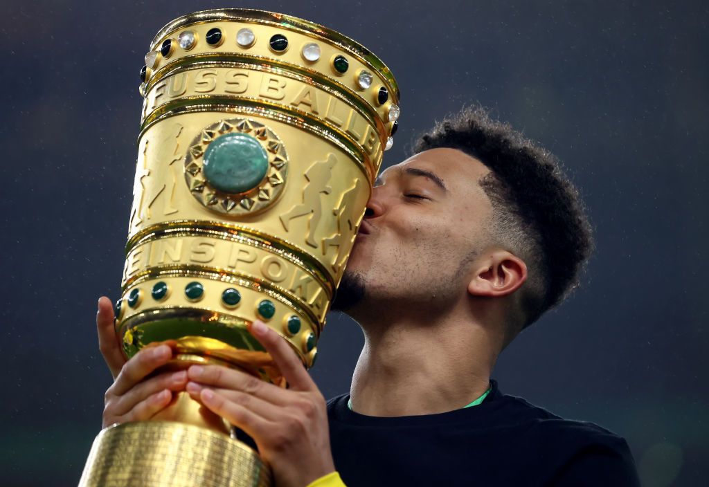 Sancho holding the DFB-Pokal trophy