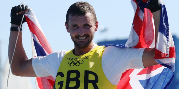 Giles Scott of Team Great Britain celebrates after winning gold in the Men's Finn class on day eleven of the Tokyo 2020 Olympic Games