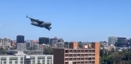 Cargo jet weaves through skyscrapers in Brisbane in tense moment