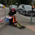 Insulate Britain protestor tied to railing with own banner by angry driver