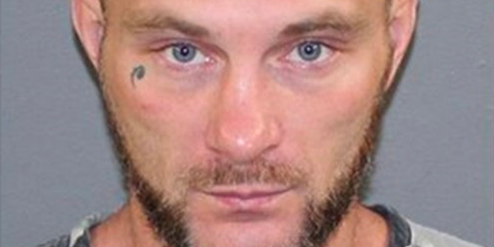 Wanted man caught by neck tattoo reading his own name