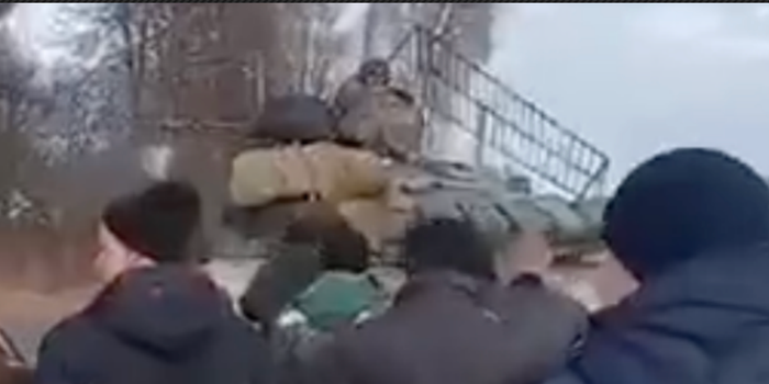 Astonishing video shows hundreds of Ukrainians force Russian tanks to stop by walking at them