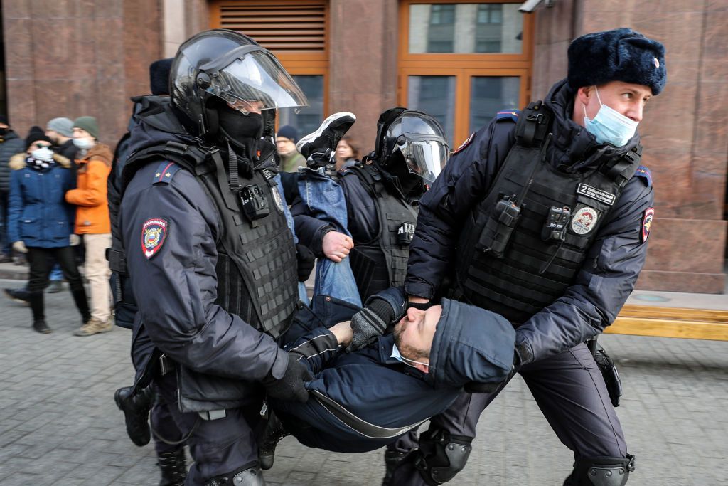 Russian police officers detain a man during an unsanctioned protest in Moscow on March 6, 2022 (Getty)