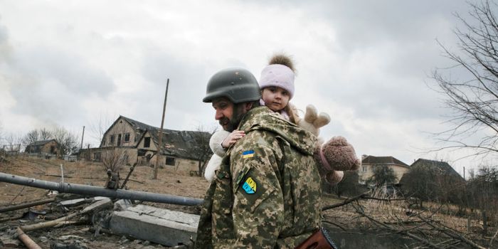 A Ukrainian soldier carries a child while evacuating from Irpin under the heavy shelling in Irpin, Ukraine on March 6 (Getty)