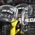 Boca Juniors players helped off pitch by riot police after Superclásico win