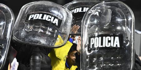 Boca Juniors players helped off pitch by riot police after Superclásico win