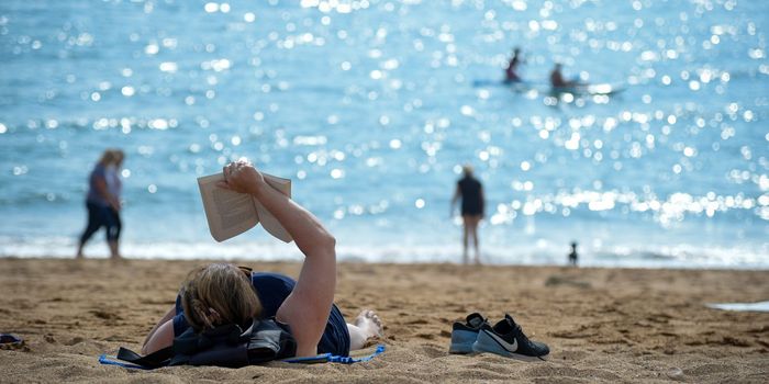 WEST BAY, ENGLAND - SEPTEMBER 08: A woman reads a book whilst enjoying the hot weather at the beach on September 08, 2021 in West Bay, United Kingdom. The United Kingdom is experiencing a late summer heatwave, with temperatures in some parts of the country expected to reach 30C. (Photo by Finnbarr Webster/Getty Images)