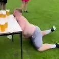 Hilarious moment rugby player taking part in beer slide challenge collides with table full of pints