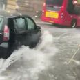 Man filmed using a broom to try clear shin-deep water during London floods
