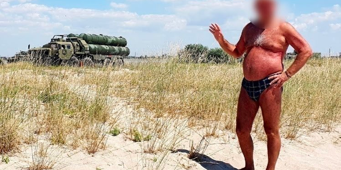Russian man swimming trunks gives away military position