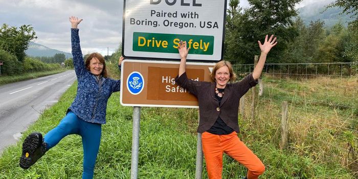 Elizabeth Leighton (left) and Emma Burtles (right) with the sing at Dull which reads: Dull, paired with Boring, Oregon, USA. See SWNS story SWNJdull; A woman who helped twin a tiny Scots village called Dull with Boring said its made it - more exciting. Elizabeth Leighton, 62, came up with the idea to link the village of Dull, Perthshire, with Boring in Oregon, after she passed through the town on a cycling holiday in 2012. Locals in Dull, which has a population of just 85, jumped at the idea to twin the two places  and said it has brought a flash of excitement to the tiny village ten years on. Dull has seen a surge in visitor numbers since 2012 and even had tourists from Boring come to celebrate the match. Elizabeth, who lives in nearby Aberfeldy, said visitors are regularly seen snapping selfies with a road sign which reads: Dull, paired with Boring, Oregon, USA.