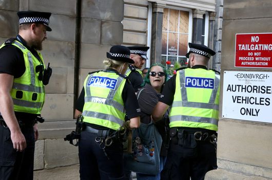 Woman with abolish monarchy sign charged with offence after arrests of republican protesters