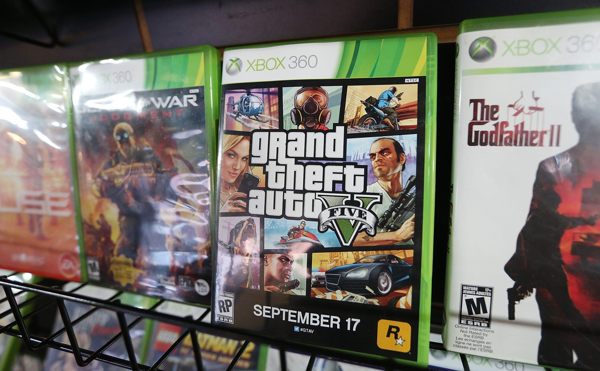 NEW YORK, NY - SEPTEMBER 18: A display copy of Grand Theft Auto V (C) sits on a shelf at the 8 Bit & Up video games shop in Manhattan's East Village on September 18, 2013 in New York City. The video game raked in more than $800 million in sales in its first 24 hours on the shelves. (Photo by Mario Tama/Getty Images)