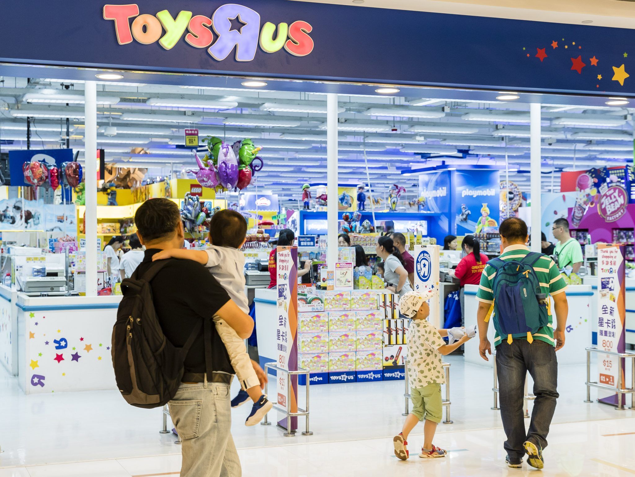 Shoppers walk towards to a Toys R US retail store at the Harbour City on August 23 2018 in Hong Kong, Hong Kong (Photo by Yu Chun Christopher Wong/S3studio/Getty Images)