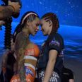 MMA fighters surprise crowd by kissing at face-off and flashing their breasts