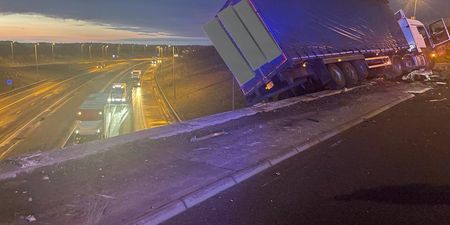 Lorry left hanging off motorway bridge after crash