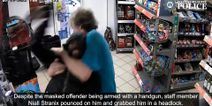 Moment Mop-wielding have-a-go-hero puts armed robber in headlock