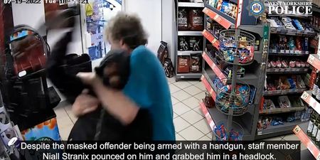 Moment Mop-wielding have-a-go-hero puts armed robber in headlock