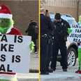 Grinch stands outside primary school with ‘Santa is fake’ sign