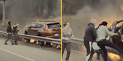 Hero bystanders rush across road to rescue man from burning vehicle